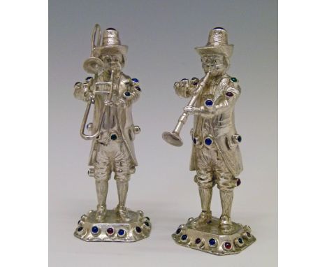Two Continental white metal figures, each depicting a 19th Century musician, one playing a trombone, the other a clarinet, ea