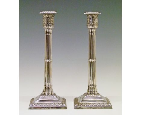 Pair of Victorian silver candlesticks, each having a reeded pillar, acanthus sconce and standing on a square stepped foot, ma