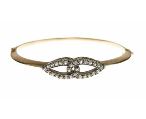 Late Victorian diamond set hinged bangle, the interlocking oval motifs frontispiece silver collet set with small old cut diam