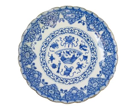 Chinese blue and white painted shallow bowl decorated in the Kangxi manner, the central fan shaped reserve depicting a lady o
