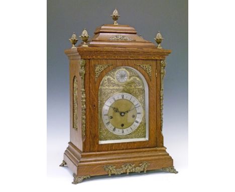 Early 20th Century oak cased bracket clock, the pagoda top with five brass pineapple finials, case with conforming brass cast