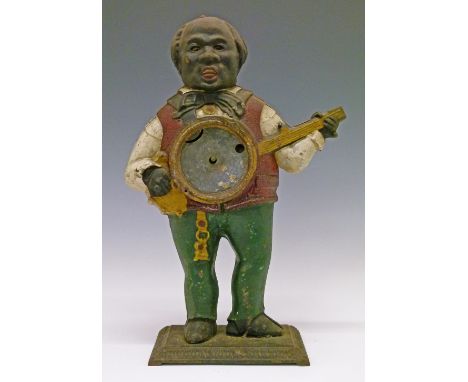 19th Century cast iron figural cased mantel clock, probably American, formed as a man playing a banjo and with moving eyes, 3