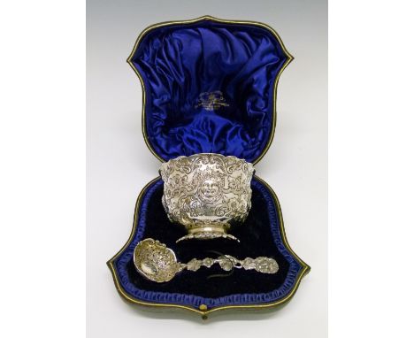 Victorian silver sugar basin having embossed Bacchanalian mask head, grapevine and foliate decoration and standing on a cast 