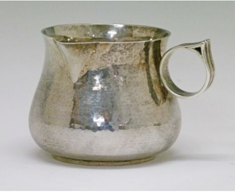 George V Guild Of Handicraft hammered silver jug having a circular side handle with reeded decoration, London 1916, 8cm high,