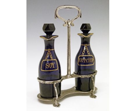 George V silver condiment stand having a central loop handle and standing on four pad feet, makers Thomas Bradbury & Sons Ltd