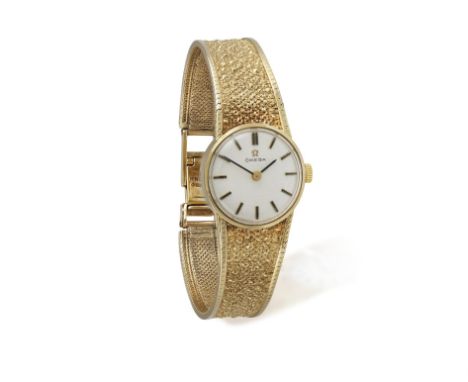 A LADY'S 9CT GOLD WRISTWATCH, BY OMEGA, of manual wind movement, the circular white dial, black hands and baton hour indicato