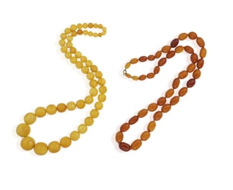 TWO AMBER-BEAD NECKLACES, the first one composed of graduated round yellowish amber beads, ranging from 0.9 - 2.5cm, total le