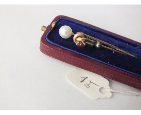 A 9ct. knot heat stick pin inset with garnet and a pearl stick  pin on gold mount       