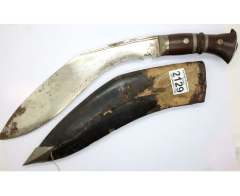 An early 20th century Gurkha Regiment kukri in scabbard. Scabbard split, blade rusted. P&amp;P Group 2 (£18+VAT for the first