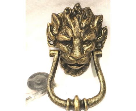 A large bronzed cast iron lion mask door knocker with fixing bolts, L: 20 cm. P&amp;P Group 2 (£18+VAT for the first lot and 