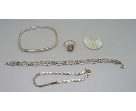 A silver bangle, two silver bracelets, a silver cluster ring, M, and a Spanish commemorative Euro coin 