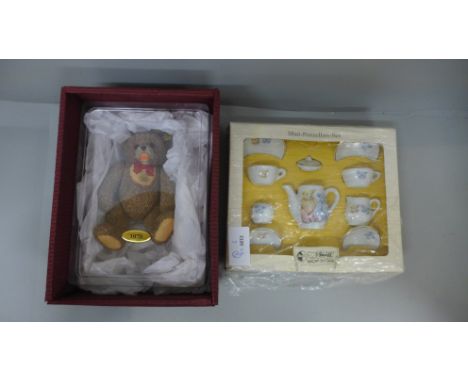 A Steiff pottery teddy bear and a Steiff dolls house miniature tea set, boxed 