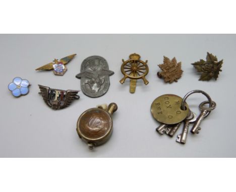 A German 1939 conference 'tinnie' badge, other badges including military and a WWII period trench art type lighter made from 