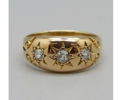 A yellow metal, three stone diamond ring, 3g, K 