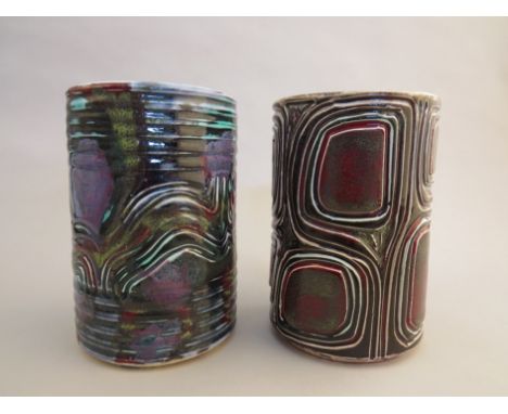 Two Poole studio cylinder vases with relief moulded design, coloured glazes (one with hairline) 15cm high 