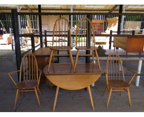 An Ercol light elm drop leaf table with two hooped stick back carvers and two chairs