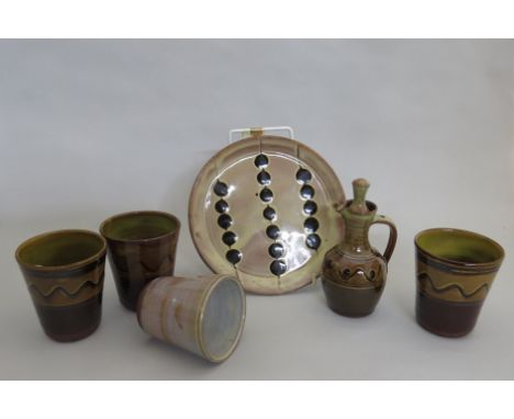 A collection of Winchcombe Pottery Sidney Tustin items including beakers, oil jug and a dish (6) 