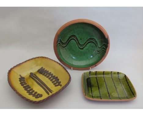 Two Winchcombe Pottery pie dishes, one by Sidney Tustin, together with a similar Yelland dish 
