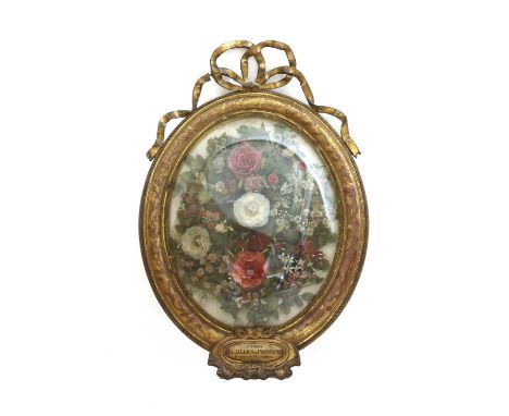 A French fish scale picture, mid-19th century, of a floral display in a gilt frame, the fish scale flower heads amongst fabri