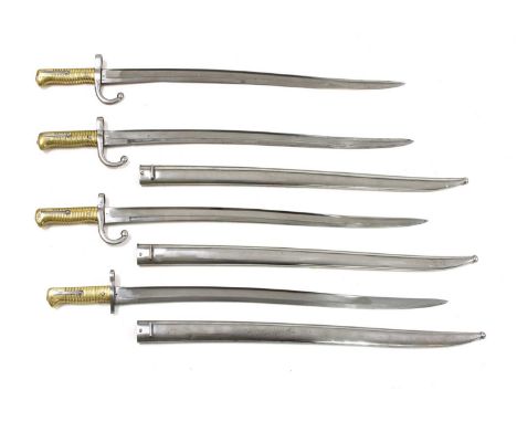 Four French brass-handled chassepot bayonets,19th century, with 57cm blades, one without a scabbard and one with a differing 