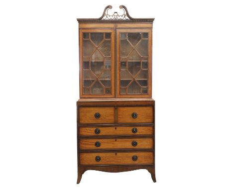 A Regency satinwood and mahogany secretaire bookcase,the top section with a fret cut swan neck cornice over astragal glazed d