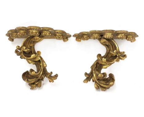 A pair of gilt softwood wall brackets,in the rococo style with carved decoration,30cm wide27cm high, anda Victorian oak wall 