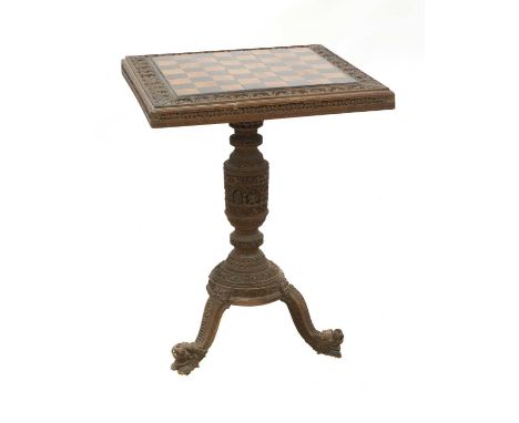 An Indian carved sandalwood chess or games table,19th century, probably Mysore, the playing surface inlaid with alternating s