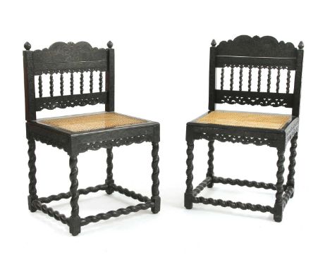 A near pair of Indian ebony side chairs,late 17th century, Coromandel Coast, the pierced and twist-turned backs profusely car