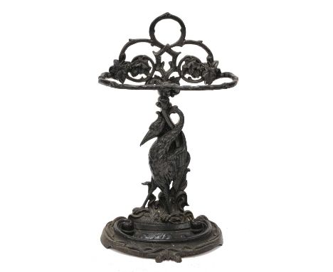 A Coalbrookdale-type patent cast iron stick stand, 19th century, the column in the form of a stork, the top as rustic branche