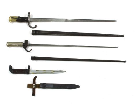 Two Martini Henry rifle bayonets with scabbards, the blades 55cm long,together with a similar bayonet without scabbard,two Gr