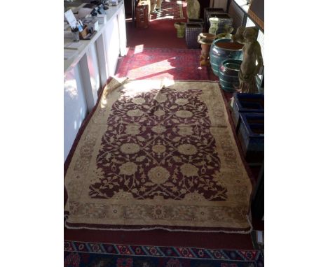 A Zeigler carpet with floral design on a claret ground 