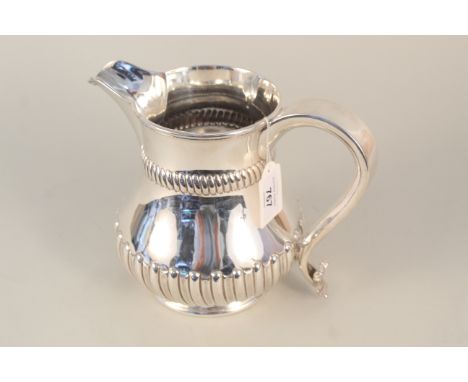 A silver water jug of half fluted design (dented), hallmarked Sheffield 1894 by Harrison Brothers &amp; Howson, approx 900g