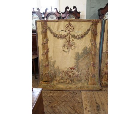 A 19th Century Aubusson tapestry depicting lovers in a rural setting flanked by floral entwined classical columns, as found
