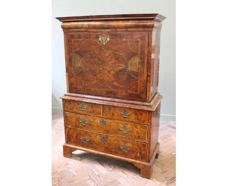 A William and Mary burr walnut escritoire, the cornice containing a convex drawer above a fall front, quarter veneered with a