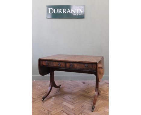 A Regency mahogany sofa table, the crossbanded top with two drawers below, supported on end stretchers with outswept legs and
