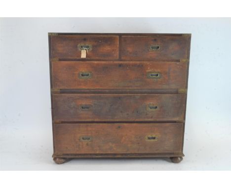 Campaign Chest. Circa 1830, Constructed of solid teak with a single piece top, with the original recessed shaped brass drop h