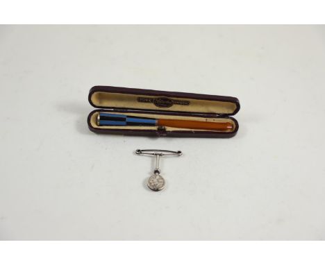 Silver napkin clip, maker GEW, Birmingham 1907, & a white metal banded, enamel & amber cheroot with casecheroot with Austrian