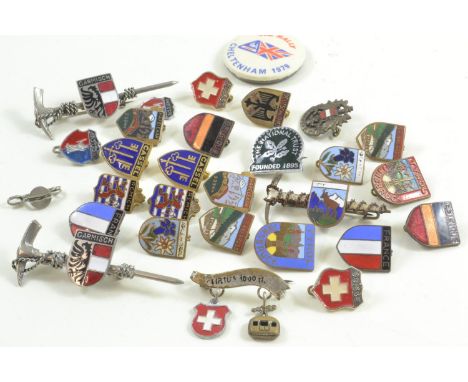 Collection of badges including enamel tourist badges