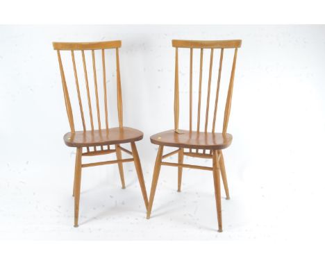 Pair of Ercol model 608 stick back chairs. One appears with damage to back rest (break where it joins seat 