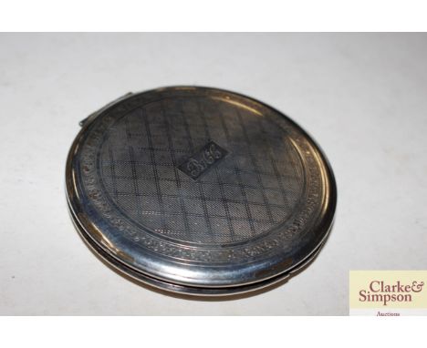 A silver compact monogrammed B.A.C.