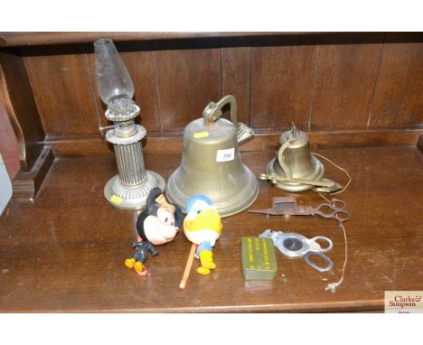 Two brass bells; a pair of candle snuffers; an oil lamp; Donald Duck and Minnie Mouse figures etc. 