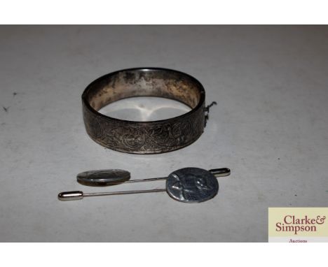 A silver and foliate engraved snap bangle and two owl decorated stick pins 