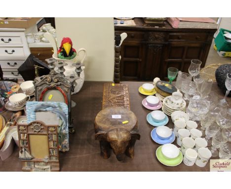 A small hardwood stool in the form of an elephant; a carved wooden trinket box; and an oak table lamp