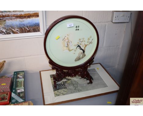 An Oriental hardstone decorated table screen; and an Oriental print of a lady with fan 