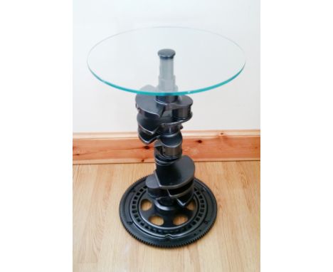 A side table based on the crankshaft from a Jaguar V8 engine. Safety Glass top bolted on. Powder coated in Anthracite.