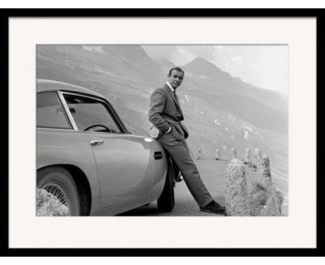 A high quality print of the legendary Sean Connery as James Bond with the Goldfinger Aston Martin DB5. The frame measures som