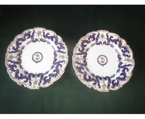 Pair of Chamberlains Worcester porcelain plate warmers each with armorial crest depicting a Griffin with blue gilt borders, p