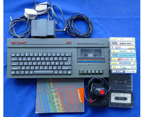 A Spectrum +2 games console (grey) S. No 066657 T complete with power supply unit, TV lead, manual, joystick, and a selection