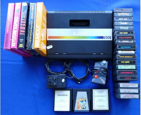 An Atari 7800 games console S No X9383220356 with power supply, TV lead, mini-stick control pad and a selection of eight game