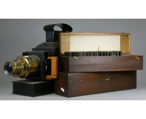 An Edwardian magic lantern projector, together with a collection of over seventy glass slides in two fitted boxes. 